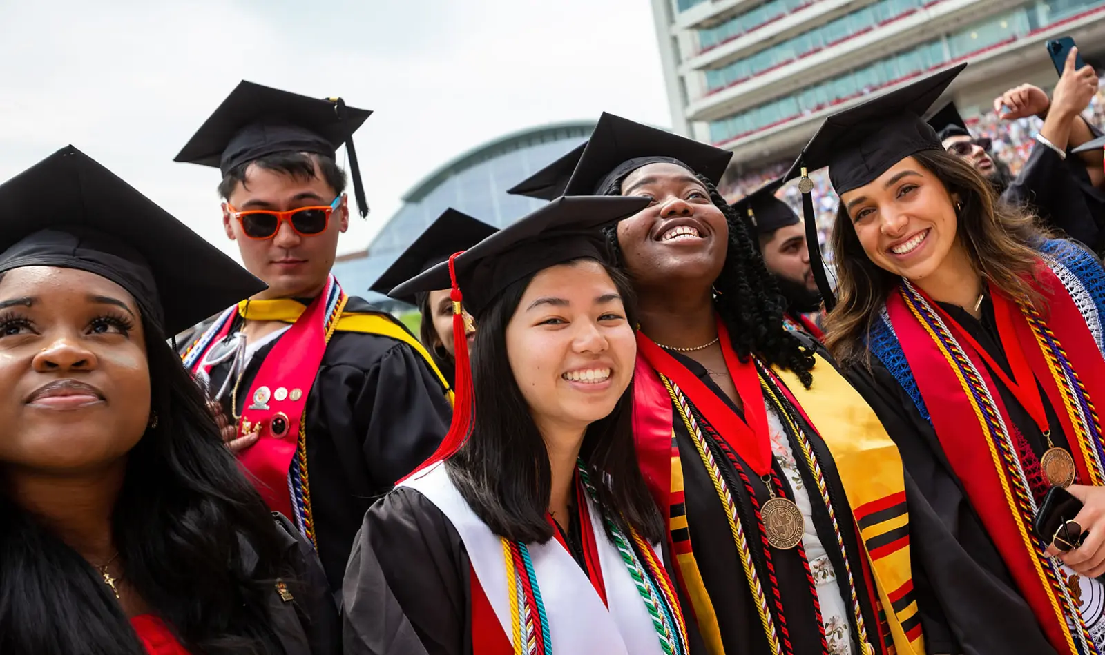 Smiling University of Maryland graduates in their regalia
